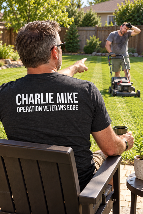 Illustrative lifestyle mockup: male veteran supervising lawn mowing, showing the full Charlie Mike back print.